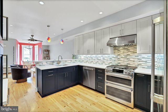 a kitchen with stainless steel appliances granite countertop a stove and a sink