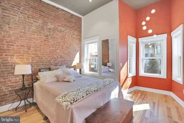 a bedroom with a bed and a large window