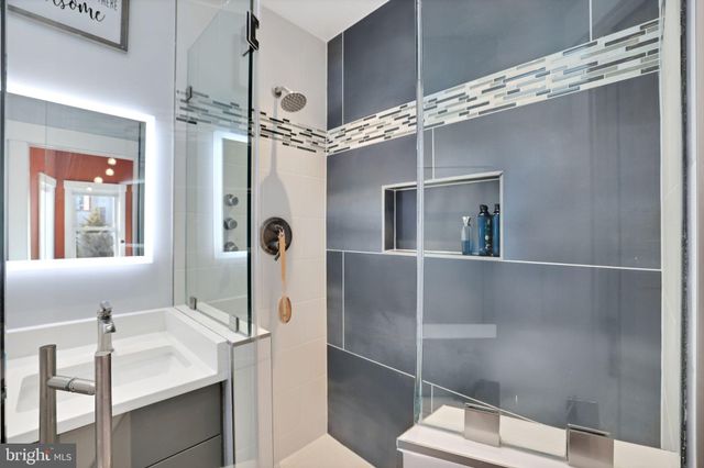 a bathroom with a sink and mirror