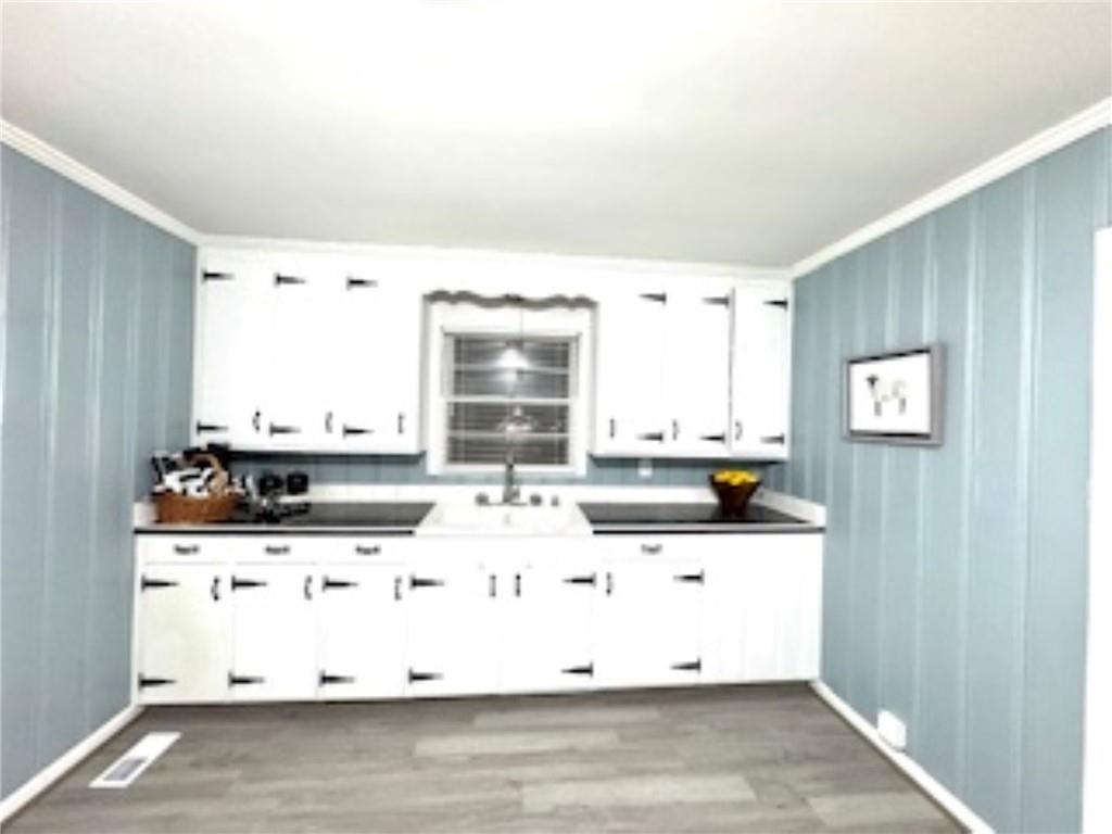 209 Moultrie Lane Southwest Rome, GA 30161 - Photo 27 of 49 a kitchen with stainless steel appliances kitchen island granite countertop a sink a stove and white cabinets