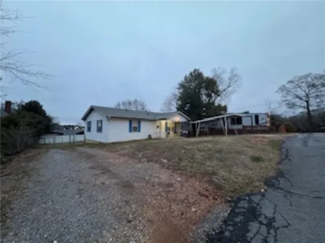a view of a backyard with a house in the background
