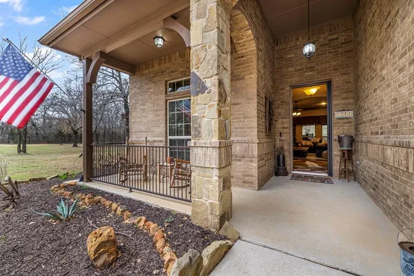 a view of a porch with a floor to ceiling window and yard