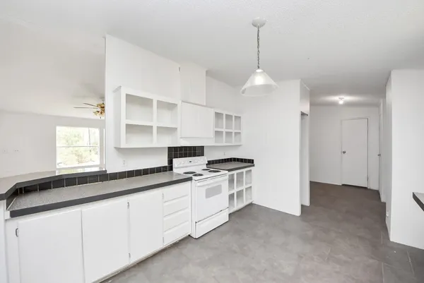 a kitchen with stainless steel appliances a sink stove and cabinets