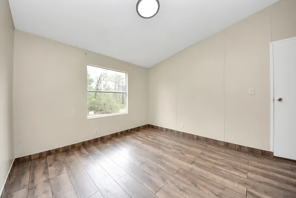 a view of an empty room and wooden floor