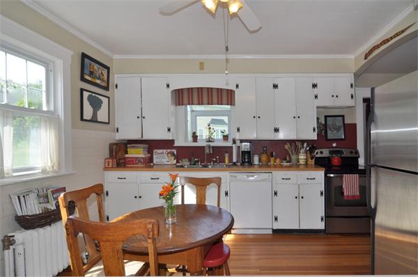 5 Highland Road Tiverton, RI 02878 - Photo 5 of 26 a kitchen with stainless steel appliances kitchen island granite countertop a dining table chairs refrigerator and sink