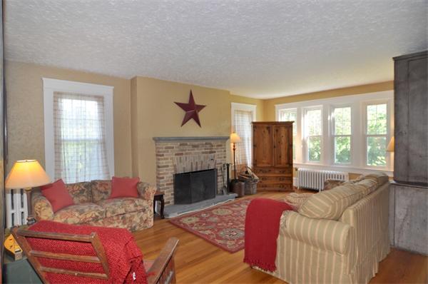 5 Highland Road Tiverton, RI 02878 - Photo 9 of 26 a living room with furniture and a fireplace