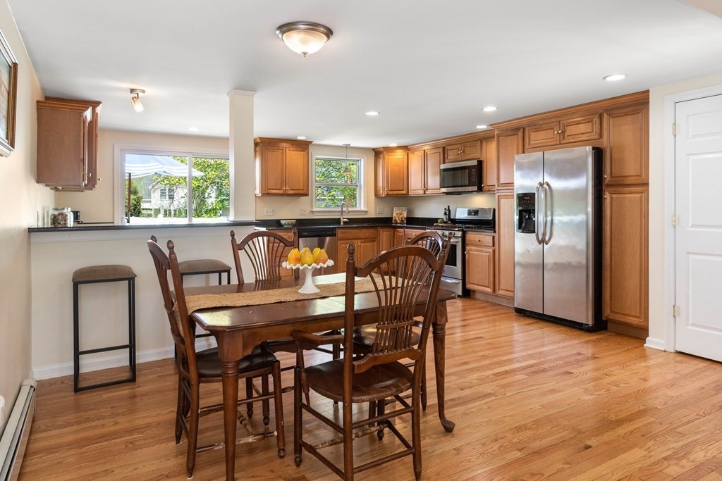 303 Hillside Road North Andover, MA 01845 - Photo 11 of 36 a view of a dining room with furniture window and wooden floor