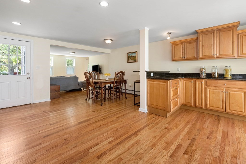 303 Hillside Road North Andover, MA 01845 - Photo 8 of 36 a kitchen with stainless steel appliances granite countertop wooden floors a stove and a microwave