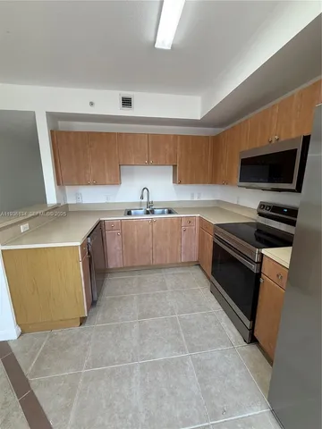 a kitchen with a refrigerator sink and microwave