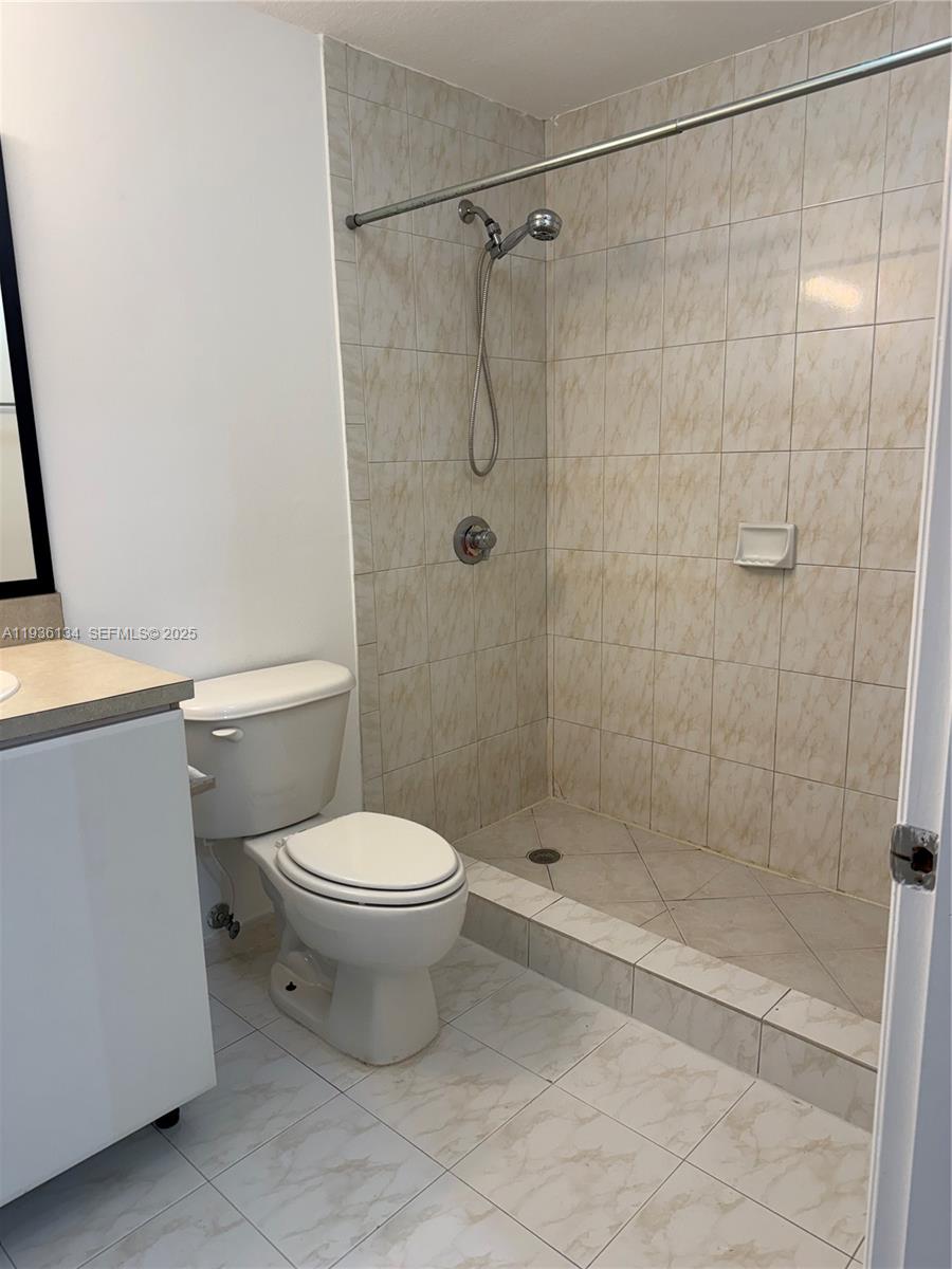 119 Southwest 6th Avenue, Unit 606 Miami, FL 33130 - Photo 8 of 20 a bathroom with a shower and a toilet