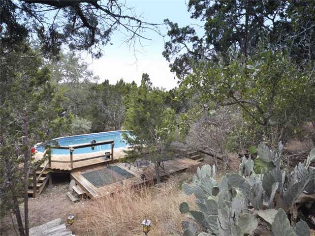 804 Woodcreek Ranch Road Wimberley, TX 78676 - Photo 1 of 1 a bench sitting in the middle of a yard