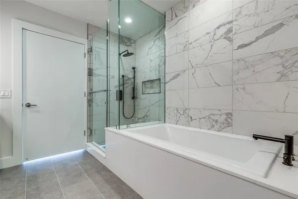 a bathroom with a bathtub and a shower