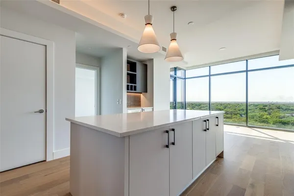 a large kitchen with a large window and stainless steel appliances