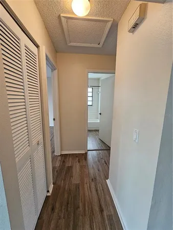 a view of a room with wooden floor and a window