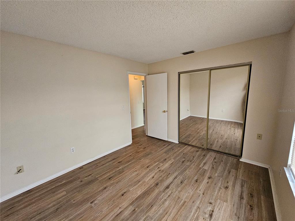 312 Oak Track Pass Ocala, FL 34472 - Photo 15 of 17 an empty room with wooden floor and entrance