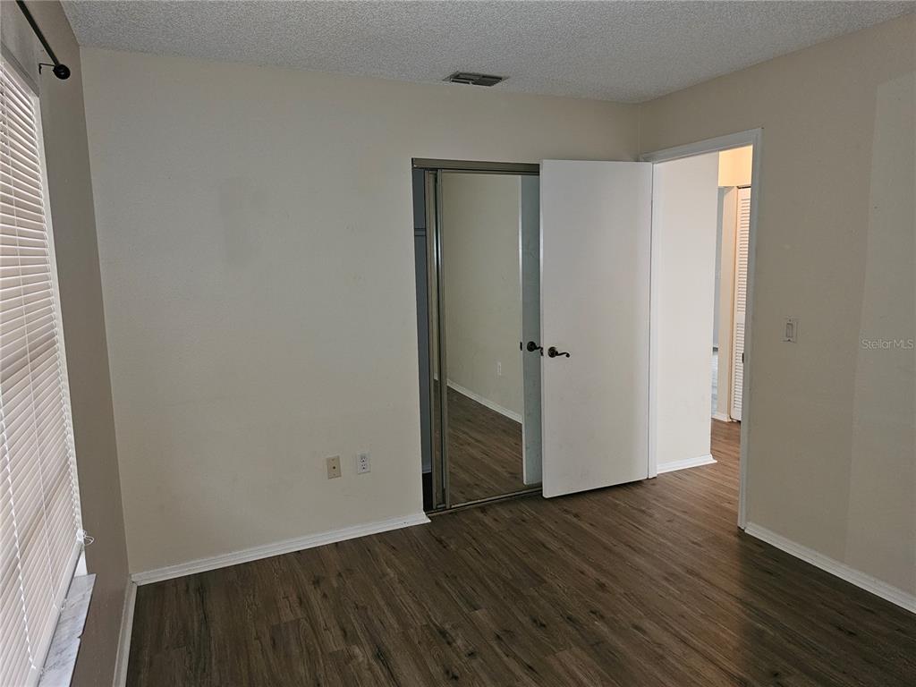 312 Oak Track Pass Ocala, FL 34472 - Photo 16 of 17 an empty room with wooden floor and closet