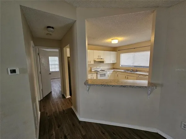 a kitchen with stainless steel appliances a refrigerator and a stove
