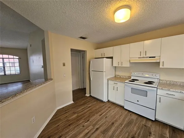a kitchen with a refrigerator a stove a microwave and cabinets