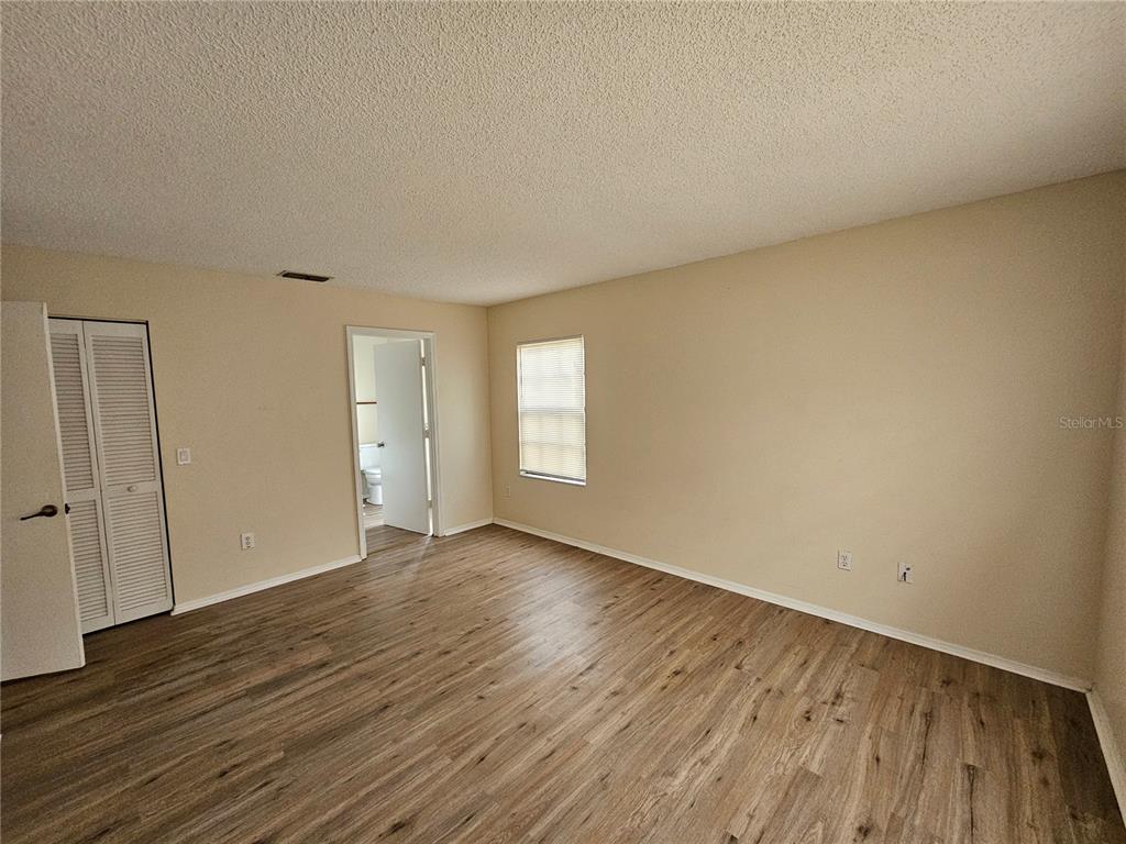 312 Oak Track Pass Ocala, FL 34472 - Photo 9 of 17 a view of an empty room with wooden floor and window