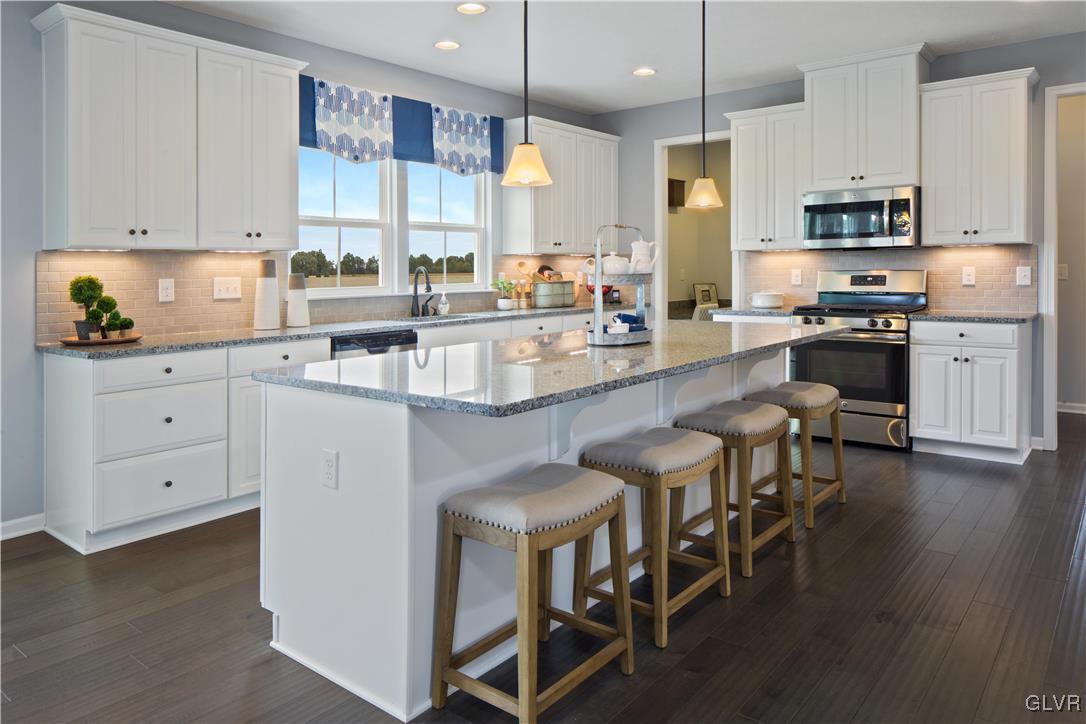 2875 10th Street Bethlehem, PA 18020 - Photo 3 of 15 a large kitchen with cabinets chairs and a wooden floor