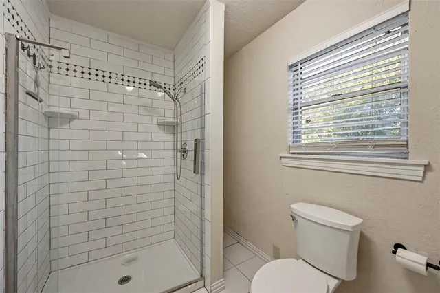 a bathroom with a shower and a toilet