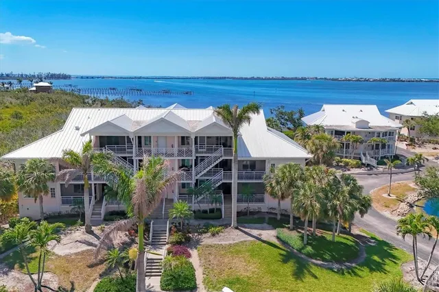 an aerial view of a house with swimming pool and lake view