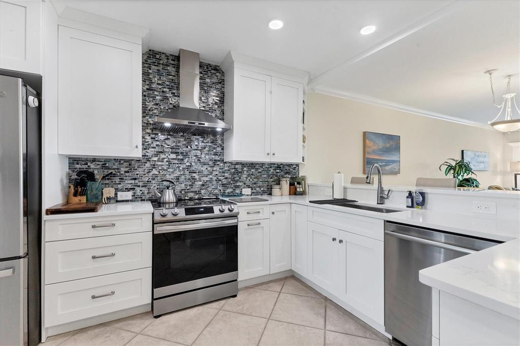 11000 Placida Road, Unit 302 Placida, FL 33946 - Photo 13 of 48 a kitchen with a stove sink and cabinets