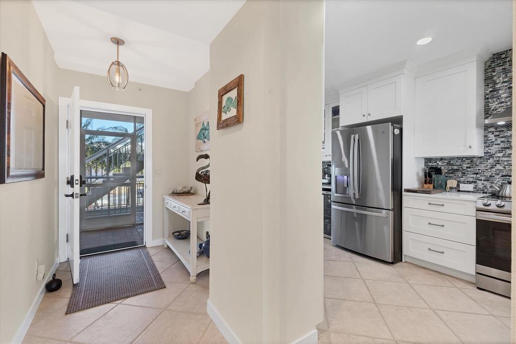 11000 Placida Road, Unit 302 Placida, FL 33946 - Photo 6 of 48 a kitchen with a refrigerator and cabinets