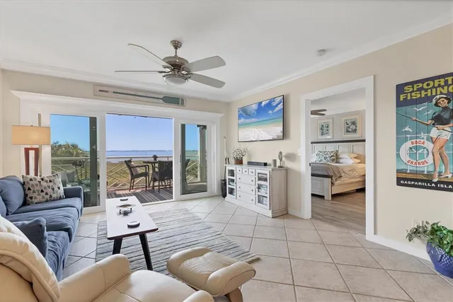 a living room with furniture and a floor to ceiling window