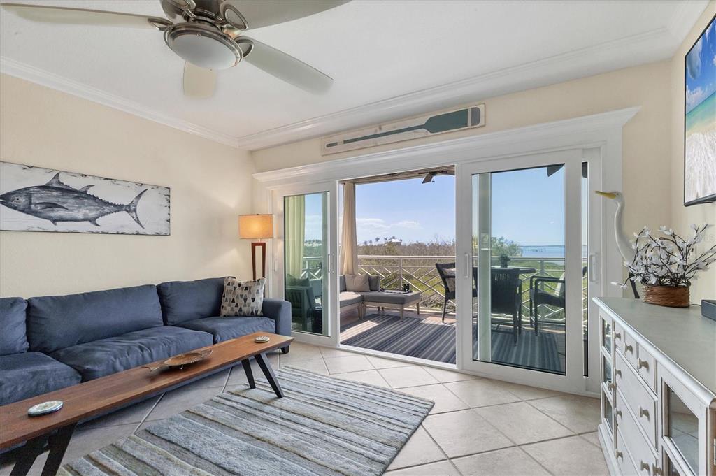 11000 Placida Road, Unit 302 Placida, FL 33946 - Photo 9 of 48 a living room with furniture and a floor to ceiling window