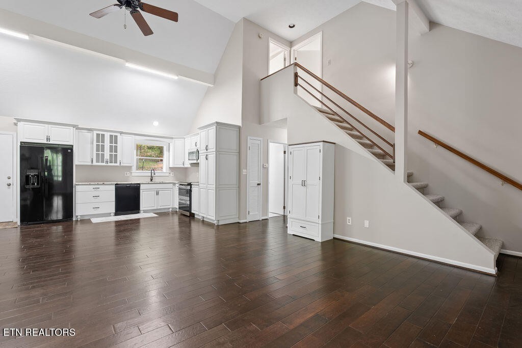 8908 Ellis Lane Powell, TN 37849 - Photo 12 of 37 a view of a hallway with wooden floor and a kitchen space with a sink