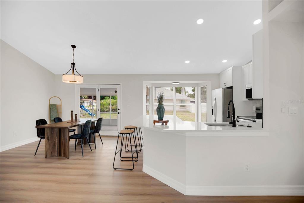 1842 Umbrella Tree Drive Edgewater, FL 32141 - Photo 11 of 32 a view of a dining room with furniture window and wooden floor