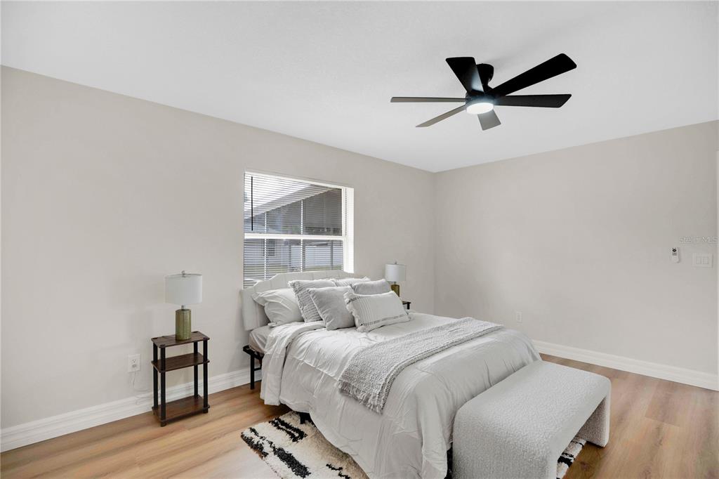 1842 Umbrella Tree Drive Edgewater, FL 32141 - Photo 14 of 32 a bedroom with a bed and wooden floor