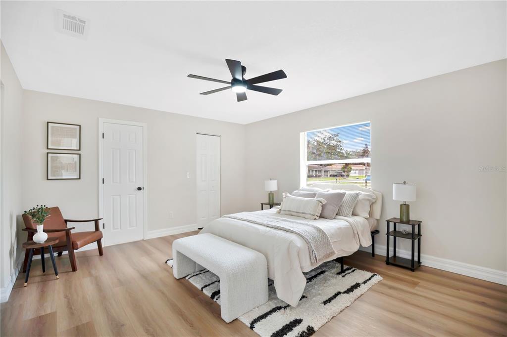 1842 Umbrella Tree Drive Edgewater, FL 32141 - Photo 15 of 32 a bedroom with a bed and a chandelier