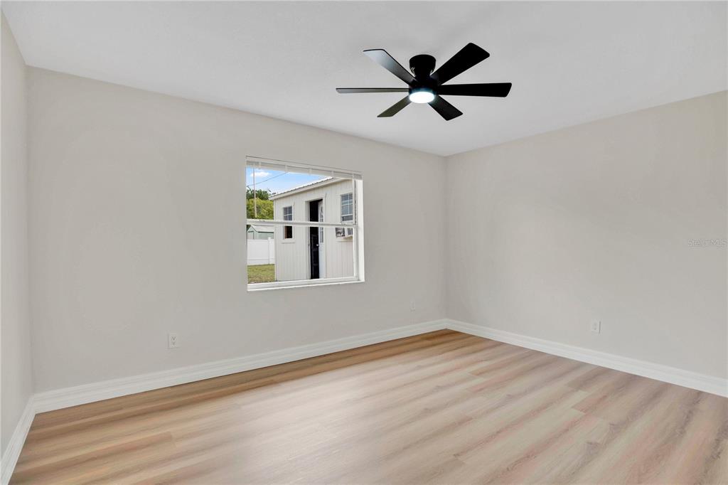 1842 Umbrella Tree Drive Edgewater, FL 32141 - Photo 18 of 32 a view of a big room with wooden floor closet and windows