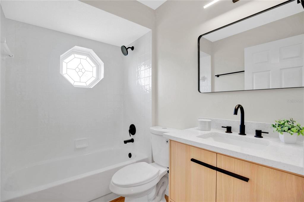 1842 Umbrella Tree Drive Edgewater, FL 32141 - Photo 19 of 32 a bathroom with a sink a toilet and a bathtub