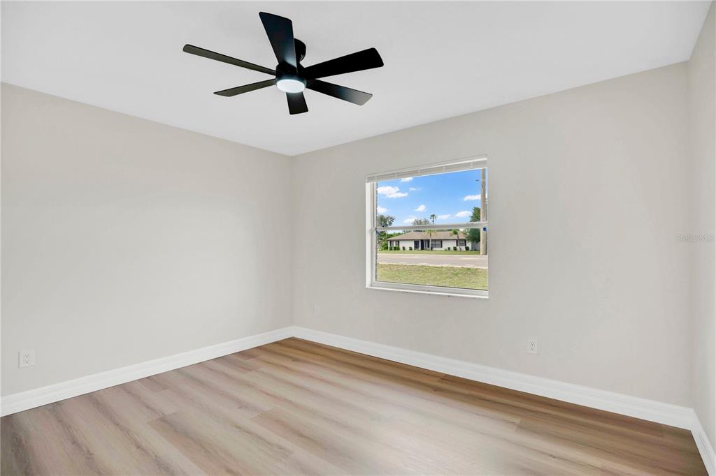 1842 Umbrella Tree Drive Edgewater, FL 32141 - Photo 20 of 32 an empty room with wooden floor and windows