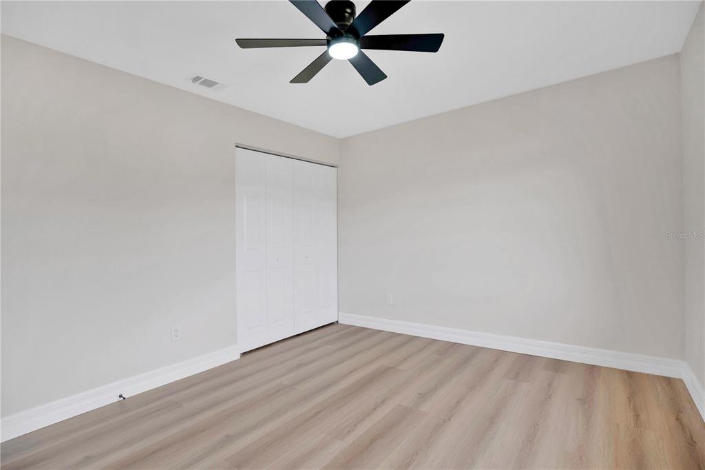 1842 Umbrella Tree Drive Edgewater, FL 32141 - Photo 21 of 32 a view of an empty room with wooden floor