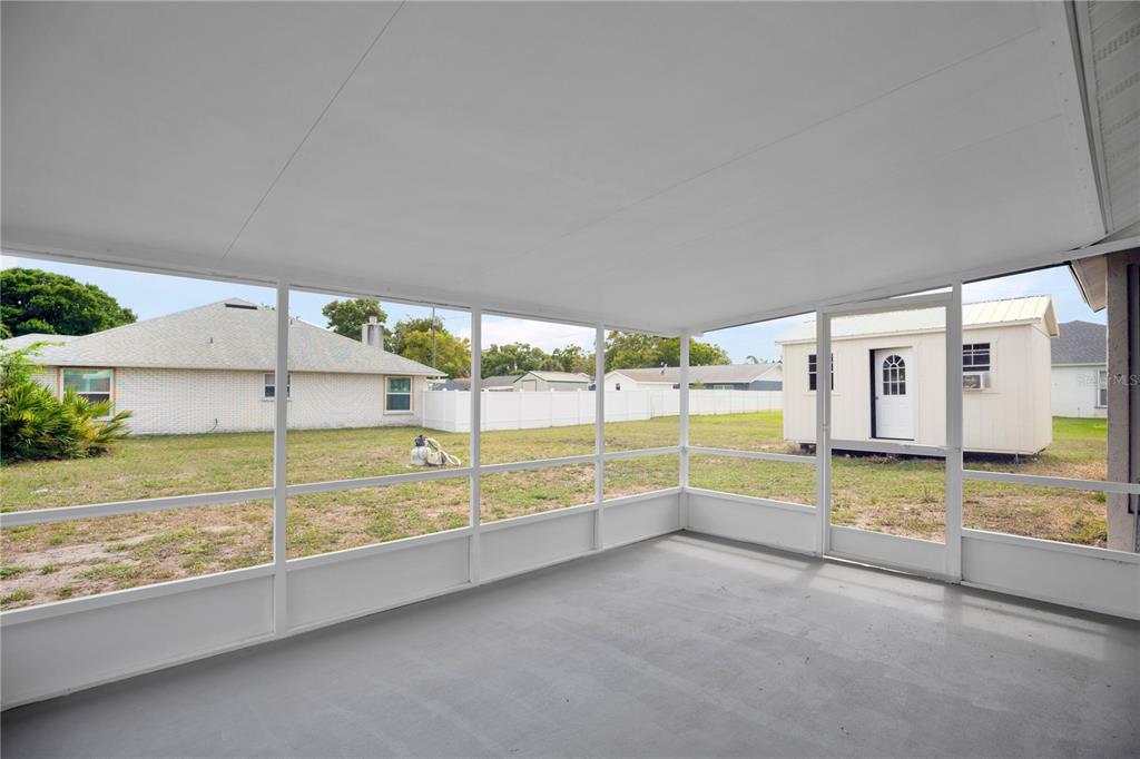 1842 Umbrella Tree Drive Edgewater, FL 32141 - Photo 23 of 32 a view of a living room and floor to ceiling window