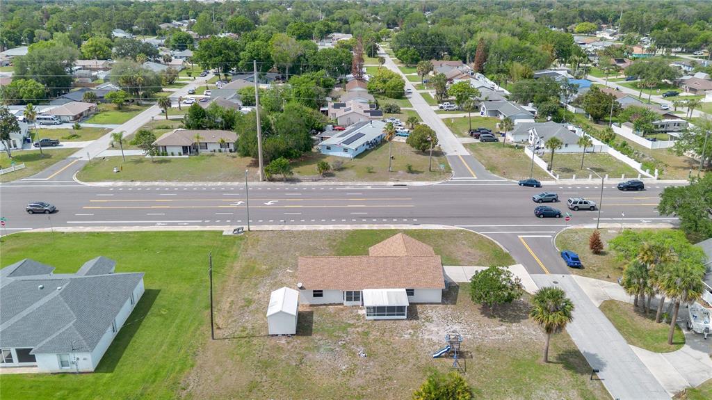 1842 Umbrella Tree Drive Edgewater, FL 32141 - Photo 30 of 32 an aerial view of a house with a yard and lake view