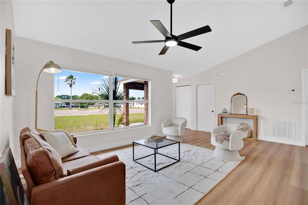 1842 Umbrella Tree Drive Edgewater, FL 32141 - Photo 5 of 32 a living room with furniture and a large window