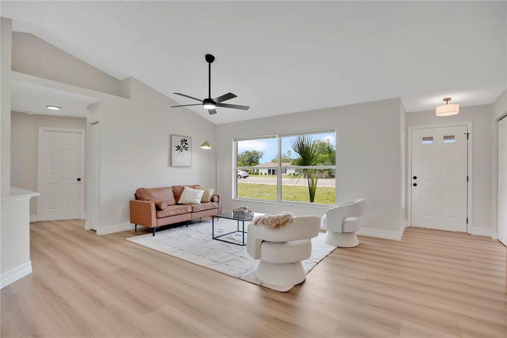 1842 Umbrella Tree Drive Edgewater, FL 32141 - Photo 6 of 32 a living room with furniture and a large window