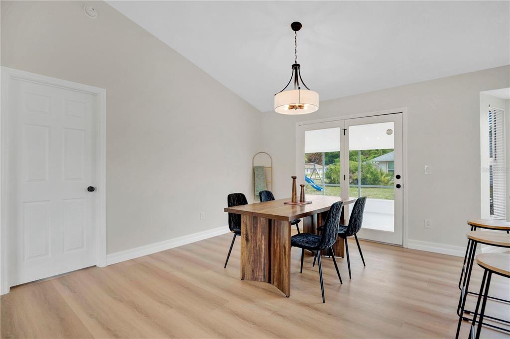 1842 Umbrella Tree Drive Edgewater, FL 32141 - Photo 9 of 32 a view of a dining room with furniture window and wooden floor