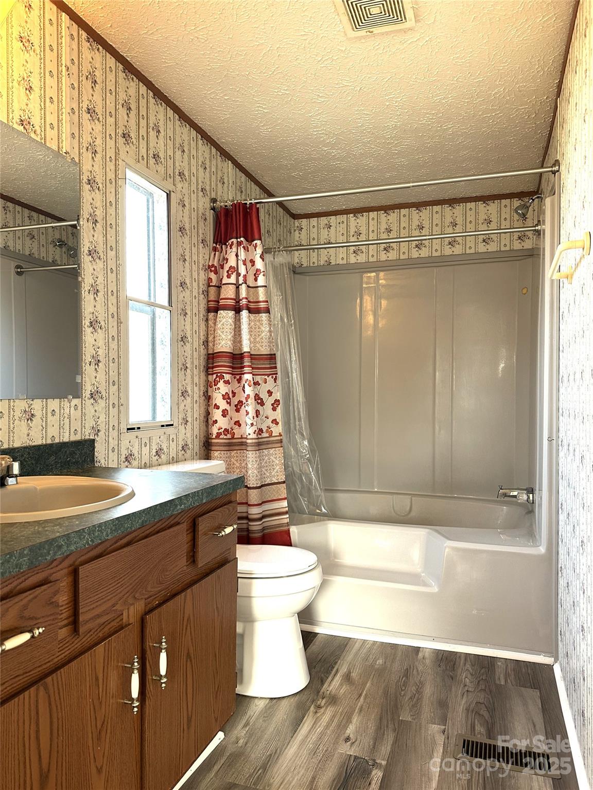 4586 Deal Road Claremont, NC 28610 - Photo 15 of 24 a bathroom with a sink a toilet and shower