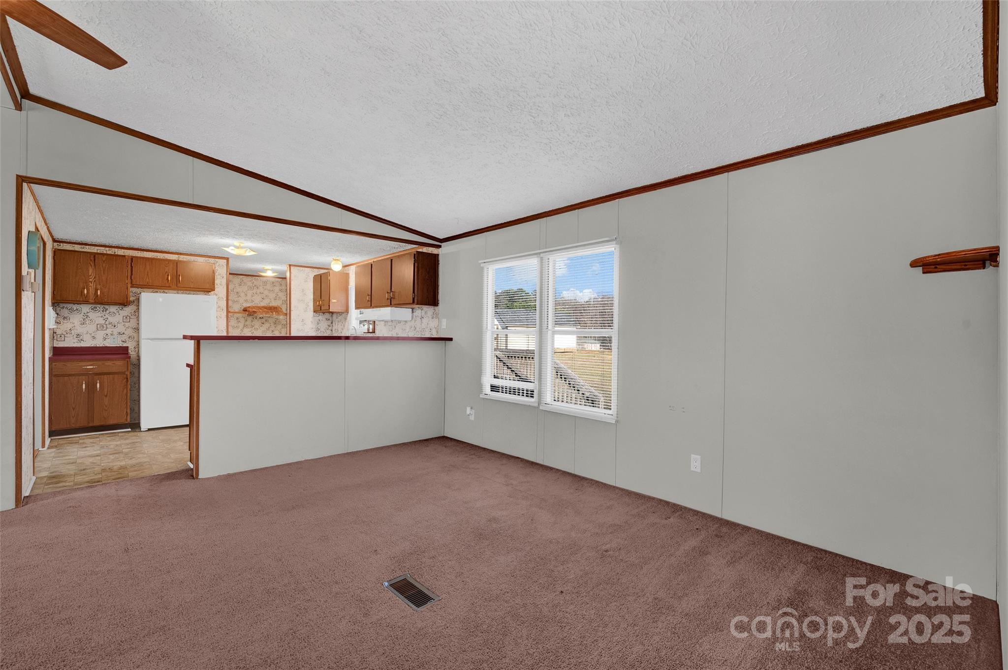 4586 Deal Road Claremont, NC 28610 - Photo 7 of 24 an empty room with a fireplace and windows