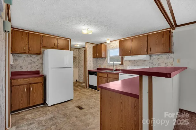 a kitchen with refrigerator and cabinets