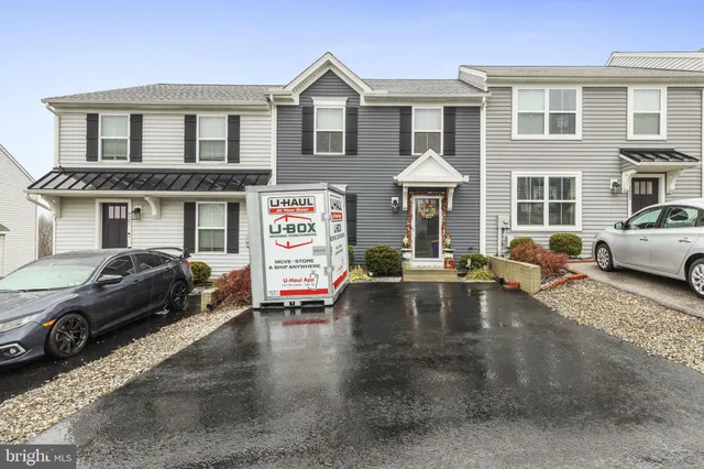 a view of a white house with a yard and balcony