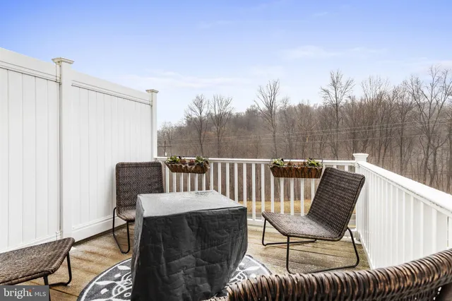 a view of a chair and table on the deck