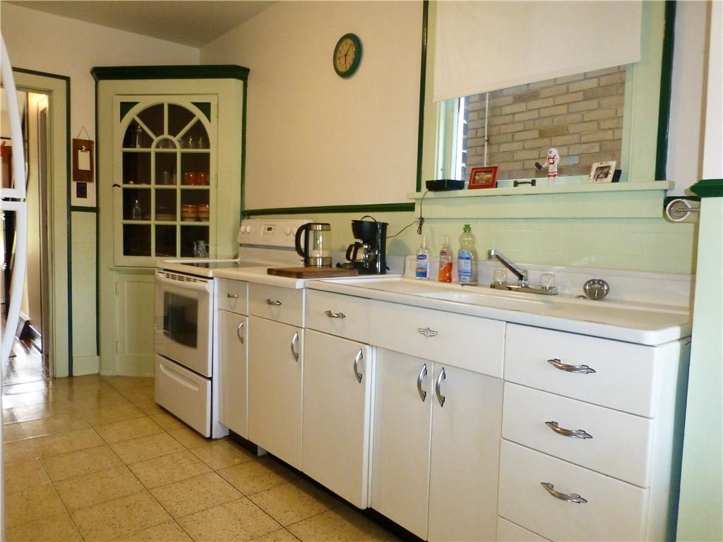 526 Ridge Avenue East Pittsburgh, PA 15112 - Photo 11 of 25 Kitchen has a built-in corner cabinet for added storage and an electric range.