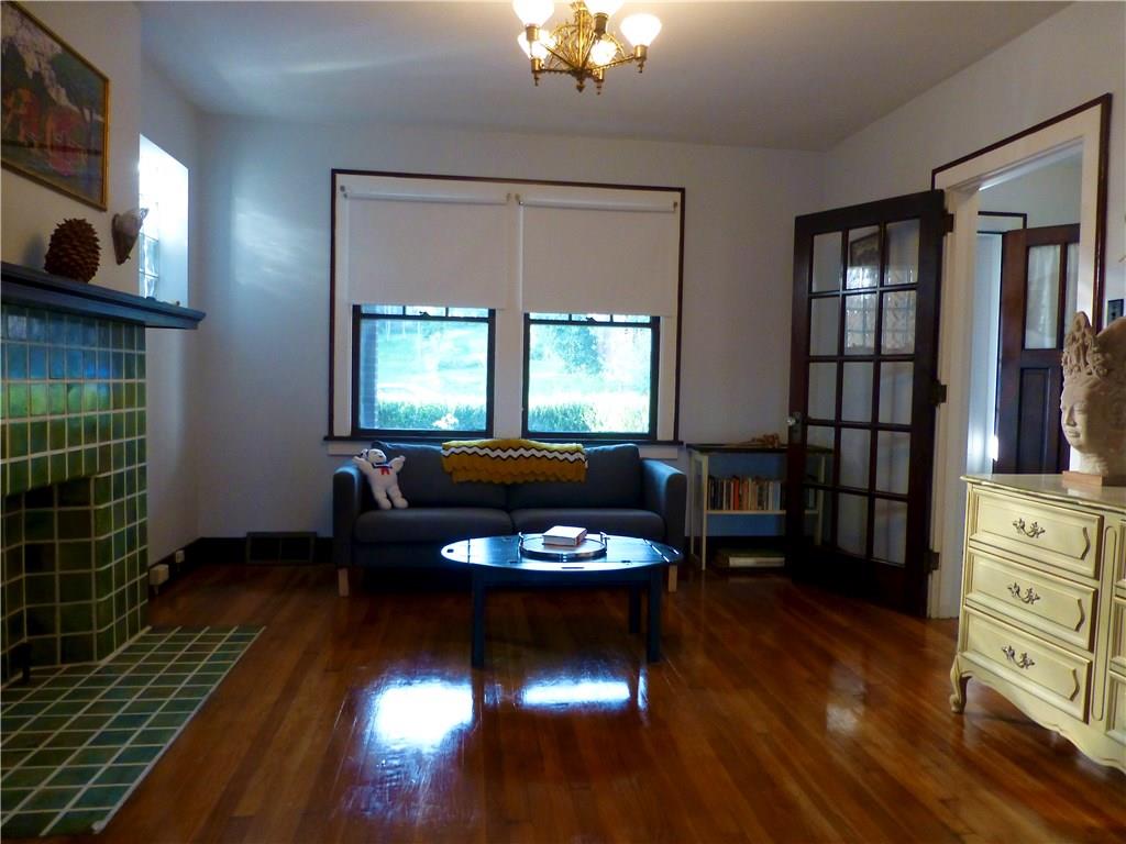 526 Ridge Avenue East Pittsburgh, PA 15112 - Photo 6 of 25 Living room has lots of natural light and a wooden and glass french style door.